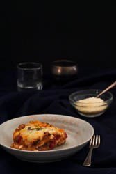 Easy Low Carb Lasagna with parmesan for garnish and red wine.