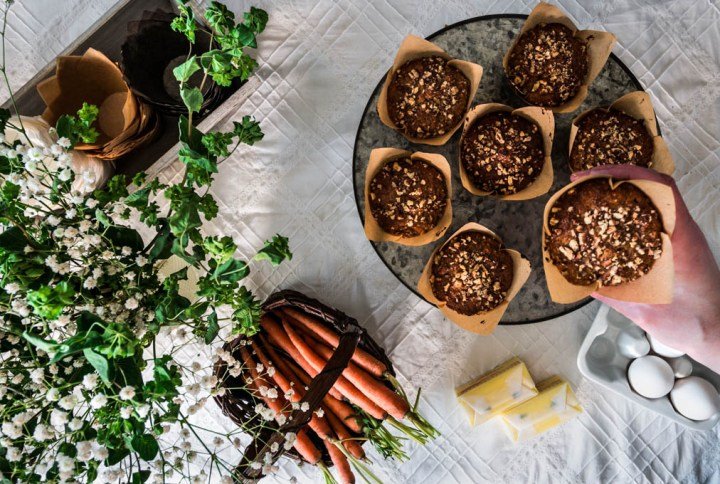 Morningstar Muffins on a cake platter, one being held in hand.