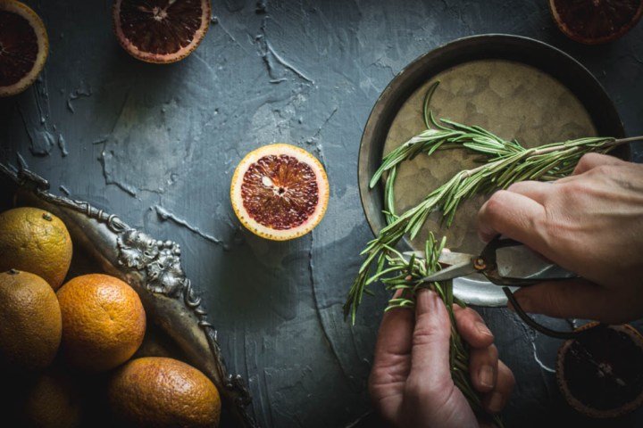 Cutting fresh rosemary for blood orange and rosemary scones.
